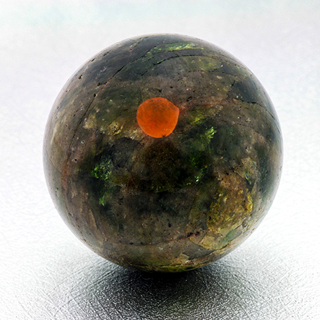 Polished sphere with calcite inclusion