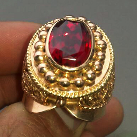 Bright red faceted ruby in a gold ring, from the large and potentially productive Snezhnoe deposit in Tajikistan.