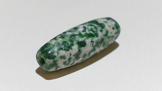 Barrel-shaped bead with unusual texture and color.