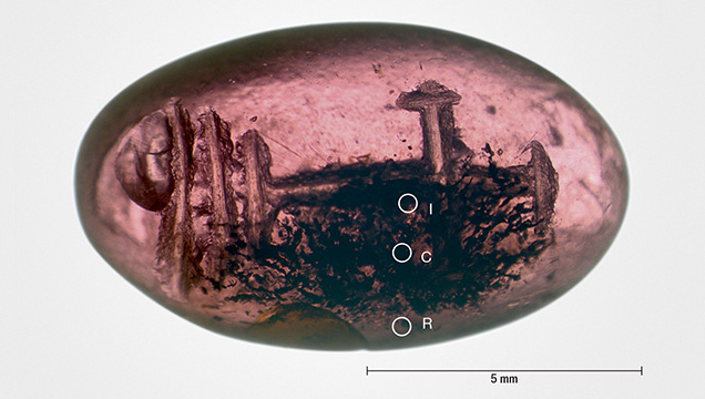 Early Byzantine garnet intaglio with inclusion-rich core and a more transparent rim