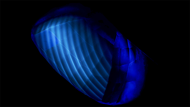 Curved banding seen in flame-fusion synthetic sapphire under short-wave UV light.