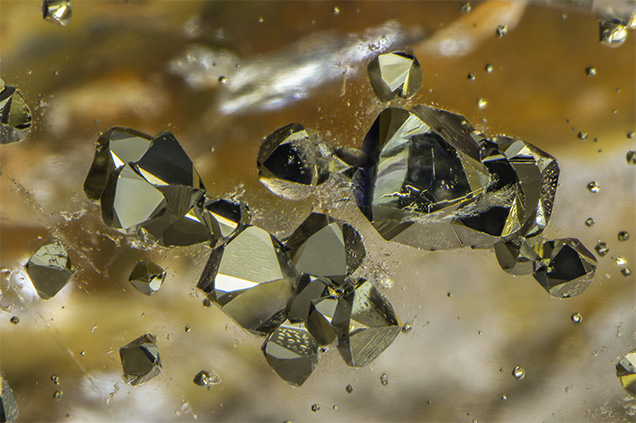 Modified octahedrons of pyrite in quartz.