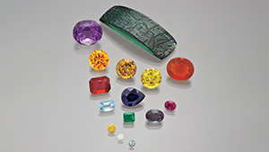 Figure 1. Synthetic alexandrite, amethyst, beryl, corundum, diamond, and fire opal. The three smallest stones are synthetic diamonds ranging from 0.06 to 0.14 ct. Photo by Robert Weldon.