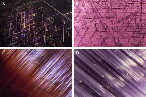 Figure 13. A: Rutile needles in star garnet. B: Needle inclusions in star spinel. C: Needle inclusions in cat’s-eye garnet. D: Linear inclusions in cat’s-eye spinel. Photomicrographs by Nathan Renfro; fields of view 3.35 mm (A), 3.38 mm (B), 1.95 mm (C), and 3.09 mm (D).