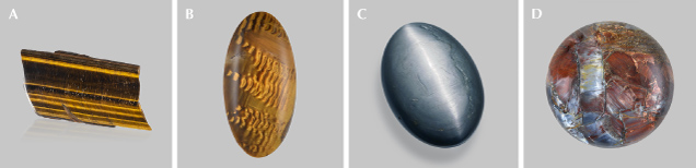 Figure 17. A: A 255 ct polished rectangular slice of tiger’s-eye from South Africa. B: A 22.03 ct tiger’s-eye cabochon from South Africa showing waves due to bent inclusions; courtesy of John I. Koivula. C: A 220 ct hawk’s-eye oval cabochon. D: A 19.82 ct pietersite round cabochon showing chatoyant fragments of different colors. Photos by Emily Lane (A and C) and Annie Haynes (B and D).