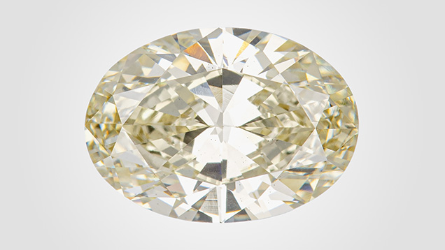 Figure 1. This 3.07 ct HPHT-treated CVD-grown diamond received a color grade of brownish greenish yellow, with the causes of color including isolated nitrogen and SiV<sup>–</sup> centers. Photo by Diego Sanchez.