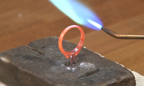 Platinum ring being soldered on a platinum silica soldering block
