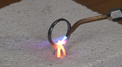 Platinum ring being soldered on a platinum ceramic soldering block
