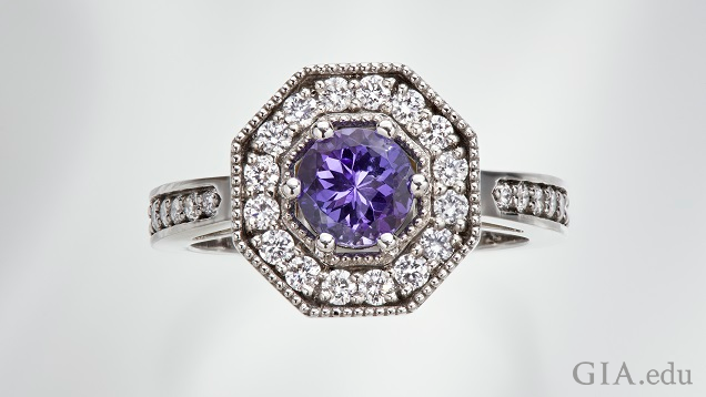 The tanzanite center stone is framed by diamonds in an octagonal frame.