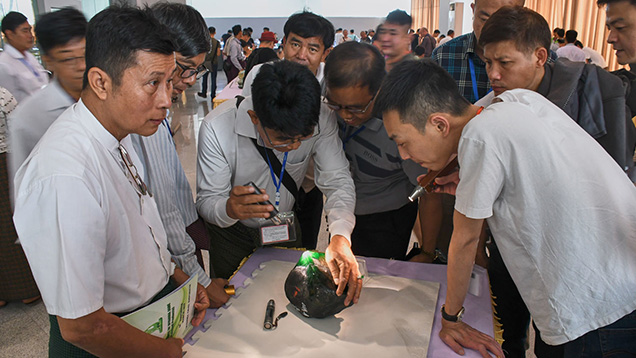 Buyers were checking the quality of a jadeite boulder