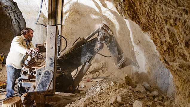 A customized digger removes opal-bearing clay