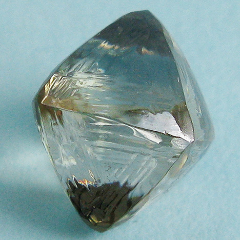 Synthetic moissanite coated with a diamond film