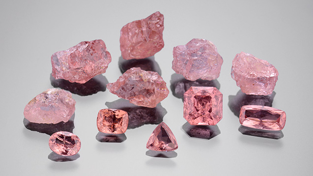 Rough and faceted pyrope garnets from Dora Maira, Italy.