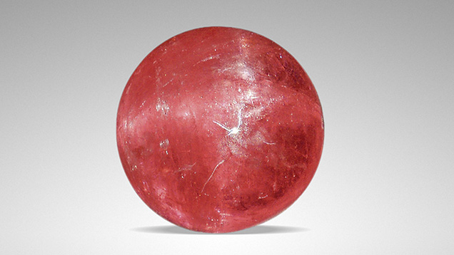 Orangy pink rhodochrosite displaying asterism.