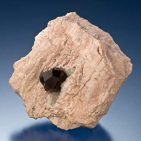 Figure 14. An almandine garnet in rhyolite from Garnet Hill in White Pine County, Nevada. Photo by Robert Weldon.