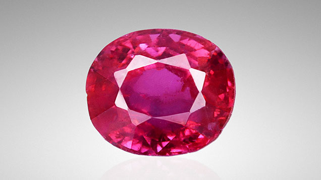Figure 1. This 0.45 ct oval-shaped ruby, measuring 4.25 × 3.65 × 3.24 mm, exhibited a highly saturated red color. Photo by Huixin Zhao.