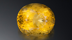 A 16.71 ct transparent orange-yellow oval sodalite measuring 17.61 × 15.74 × 12.88 mm. Photo by Lhapsin Nillapat.