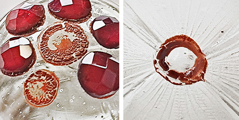 Figure 14. Residues of the reddish brown fixation layer on the glass substrate of the lidded goblet in Munich; the diameters of the reddish brown residual materials measure 4 and 3 mm (left, center and bottom, respectively) and 3 mm (right). Photos by H.A. Gilg.