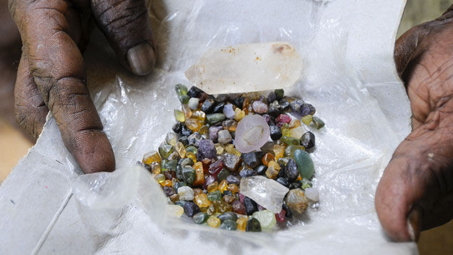 Figure 10. A typical mix of gems including garnet, quartz, topaz, sapphire, chrysoberyl, and zircon found by miners in Ratnapura, Sri Lanka. This secondary deposit includes gems potentially from multiple sources, each with its own distinct geological story, weathered out of host rocks and found together in rivers running through the valleys. Photo by Wim Vertriest.