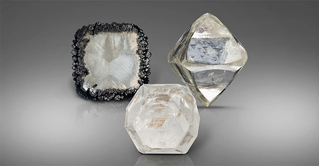 Figure 6. The different growth conditions of natural and laboratory-grown diamonds provide distinctive clues that allow gemologists to conclusively separate them. Here laboratory-grown CVD (left) and HPHT (middle) rough diamonds are pictured next to a natural rough diamond (right). Photos by Robert and Orasa Weldon; courtesy of the GIA Sir Ernest Oppenheimer Student collection (left).
