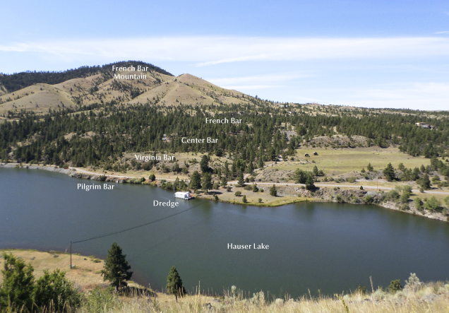 Figure 3. The view southwest across Hauser Lake from Riverside Campground. The French Bar complex starts underwater in Hauser Lake and continues steeply uphill southwest to the historic 1867–1869 hydraulic gold mining area, known as French Bar. The sapphire-bearing French Bar sill is poorly exposed and lies partially on Virginia Bar and Center Bar. Photo by Richard B. Berg; courtesy of the Montana Bureau of Mines and Geology.