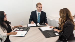 Three happy employees in professional attire 