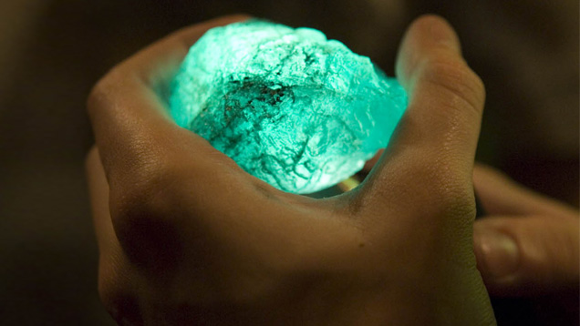A miner holds an emerald in the mine office in the village of Coscuez, Colombia. Photo by Eric Welch/GIA